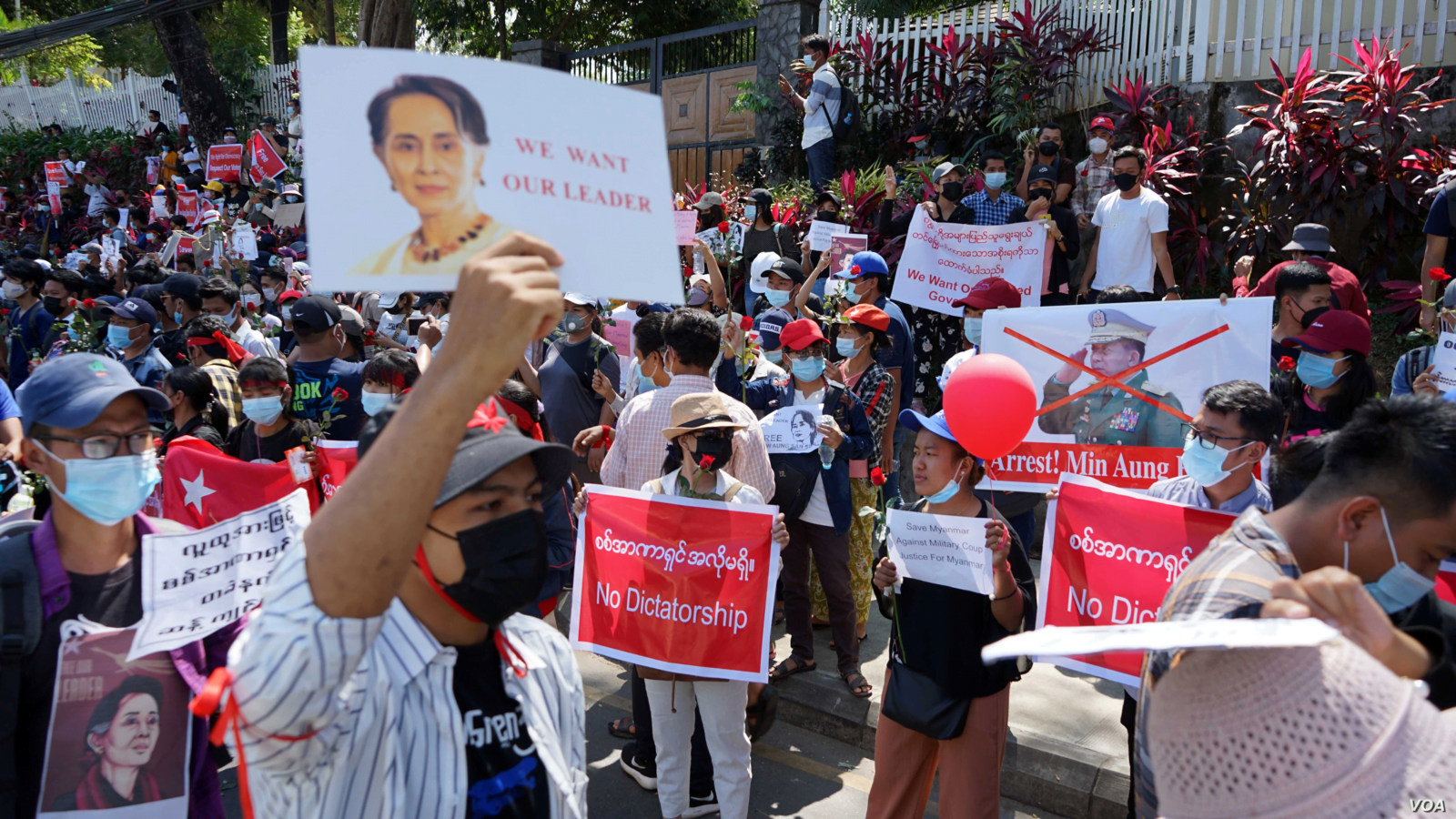 Demonstrators denounce a military coup while holding signs for the return of Aung San Suu Ky, their de facto civilian leader.