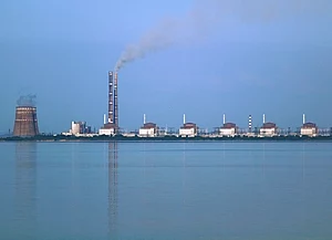 Calm Kakhovka Reservoir waters at the edge of the at-risk Russian-occupied nuclear reactor complex in Zaporizhia.
